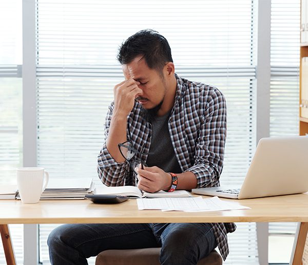 a stressed man sitting at a desk