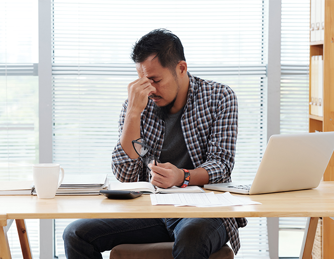 a stressed man sitting at a desk