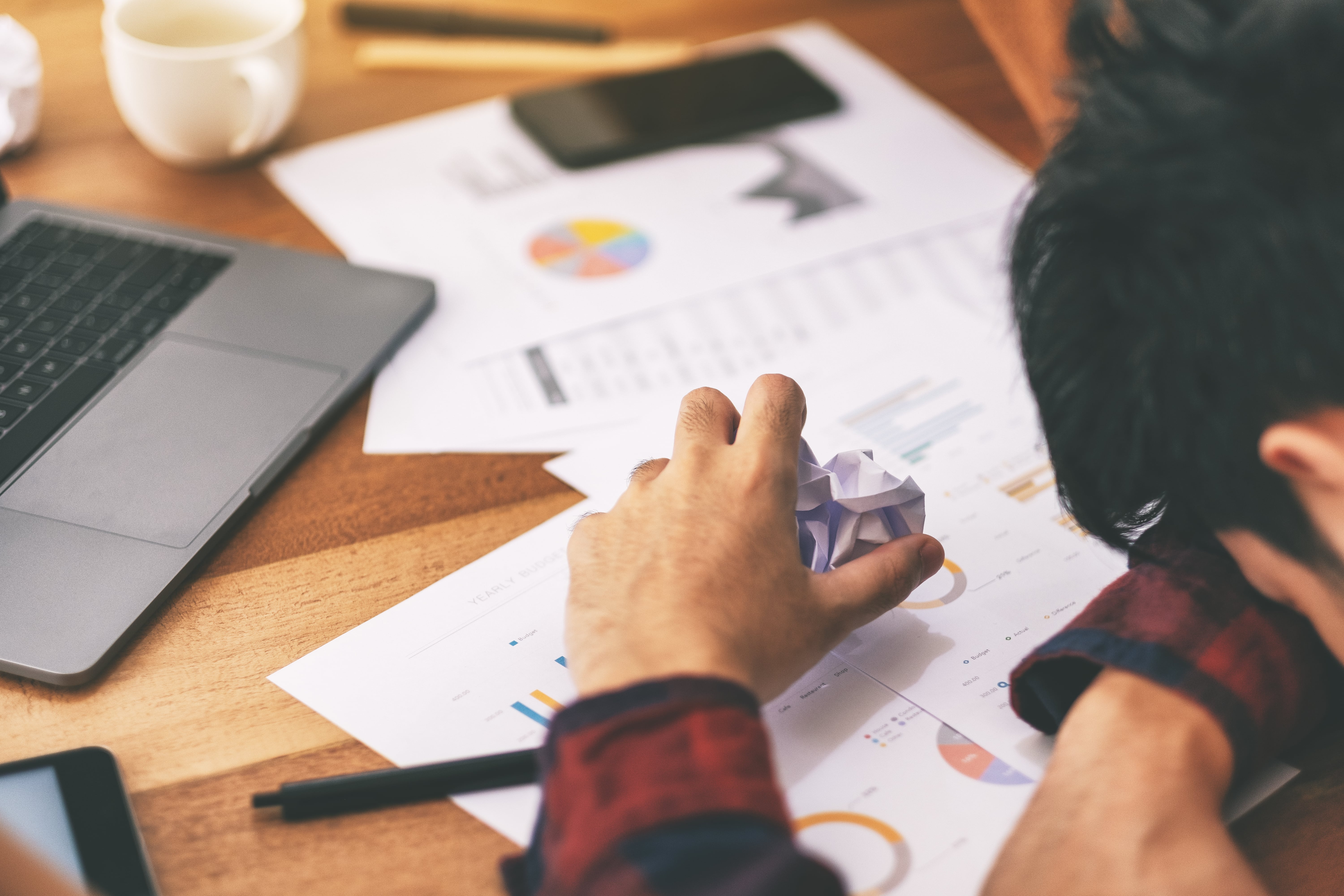 A picture of a business man surrounded by crumpled paper