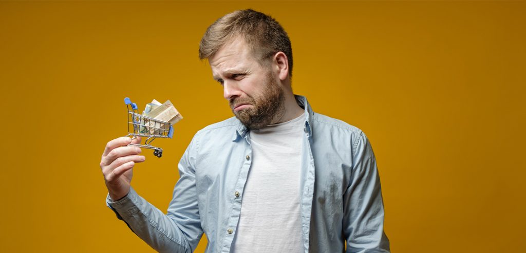 Man upset about inflation holding small shopping trolley