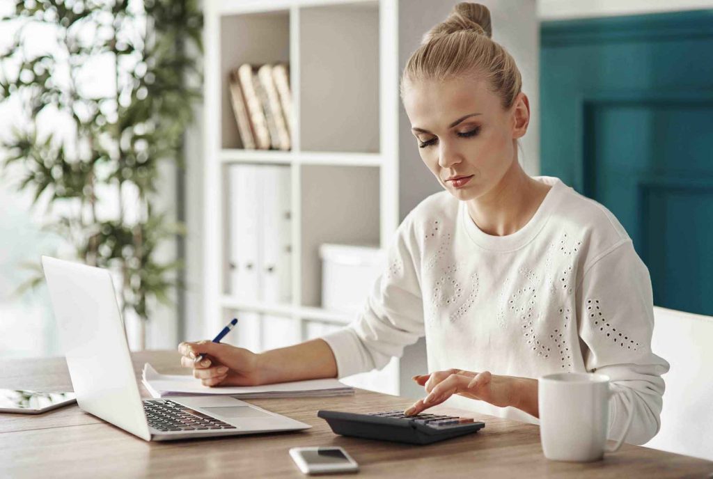 A picture of a woman working out her finances 