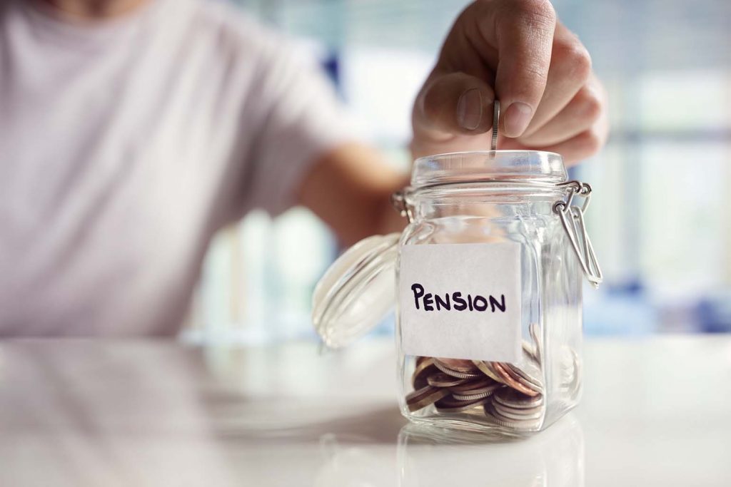 An image of a person putting money in a pension savings pot