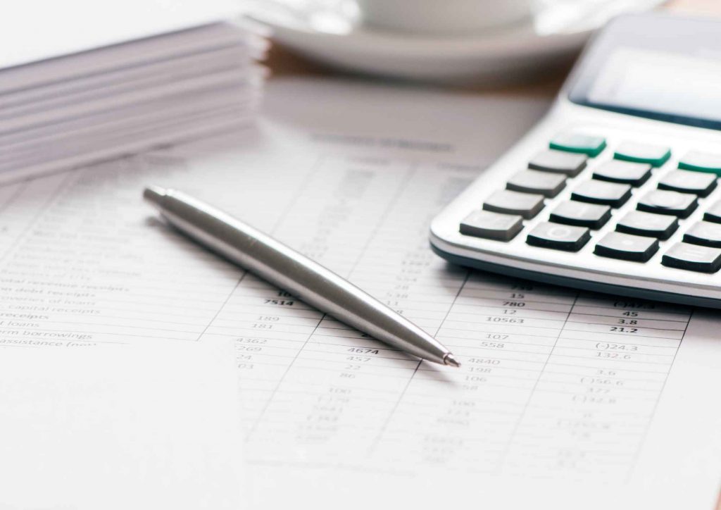 An image of a calculator and pen