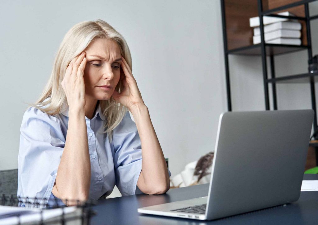 An image of an older woman looking sad